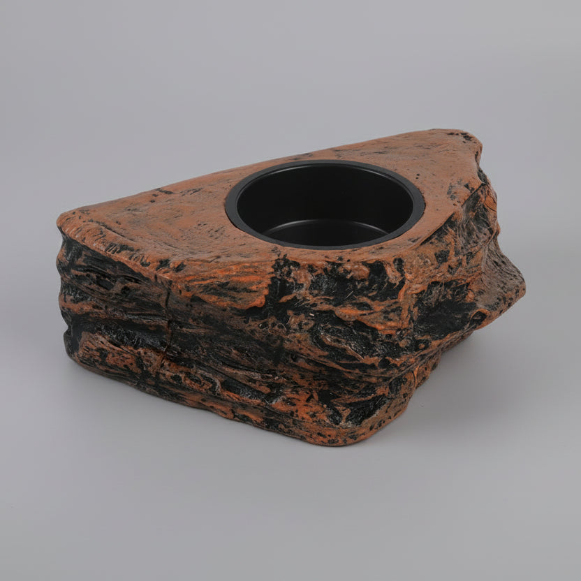 Decorative rock-shaped feeding bowl with a black interior on a white background