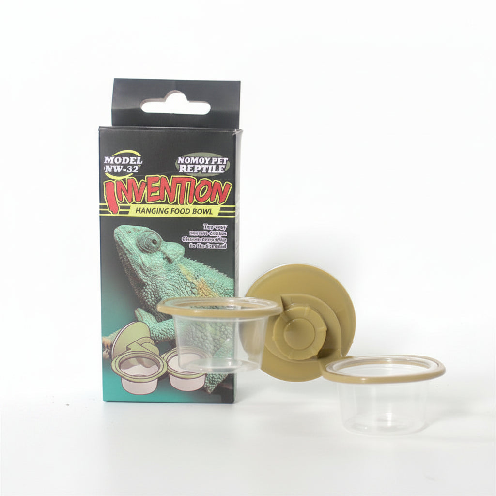 NOMOY PET Invention Hanging Food Bowl for reptiles and amphibians, shown with its retail packaging box, a tan suction cup, and two clear plastic food bowls on a white background.
