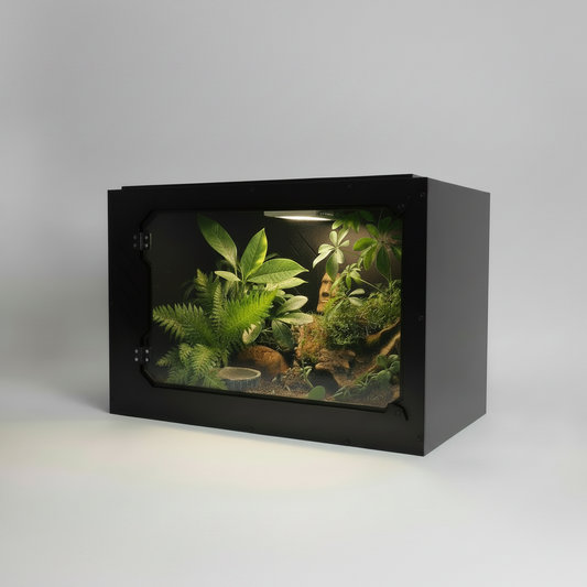 Small pvc reptile enclosure with plants and rocks on a gray background