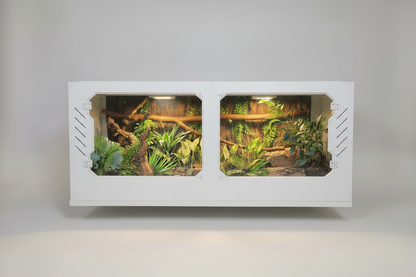 White PVC Reptile terrarium with plants and branches on a gray background