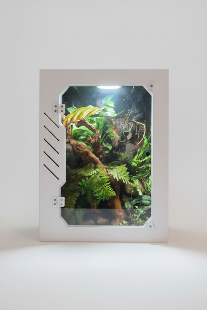 PVC reptile enclosure with plants inside on a white background