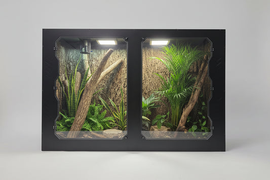 Reptile terrarium with plexiglass doors, plants, and branches on a white background