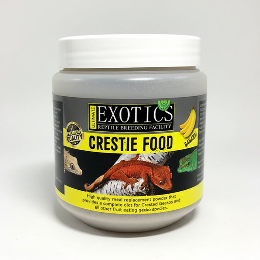 A jar of Exotics Reptile Breeding Facility Crestie Food banana-flavored meal replacement powder, featuring a black and yellow label with an image of a red crested gecko on a white background.