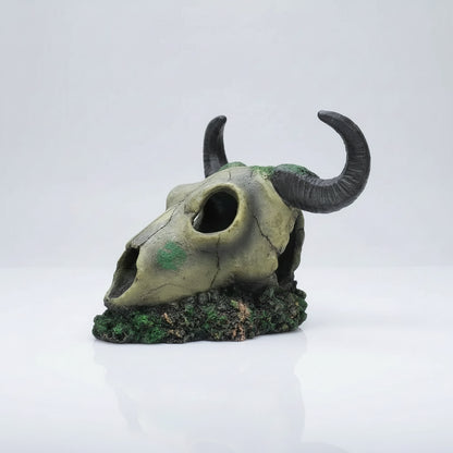 A decorative animal skull aquarium ornament with curved horns and a mossy base, shown on a plain white background. The brand name AQUAPET is printed on the side.