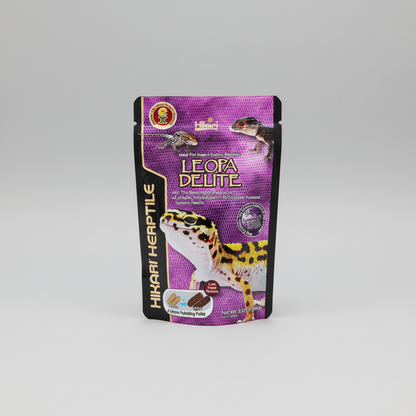 A stand-up pouch of Hikari Herptile Leopa Delite food, featuring a purple and black design with leopard illustrations, photographed on a neutral gray background.