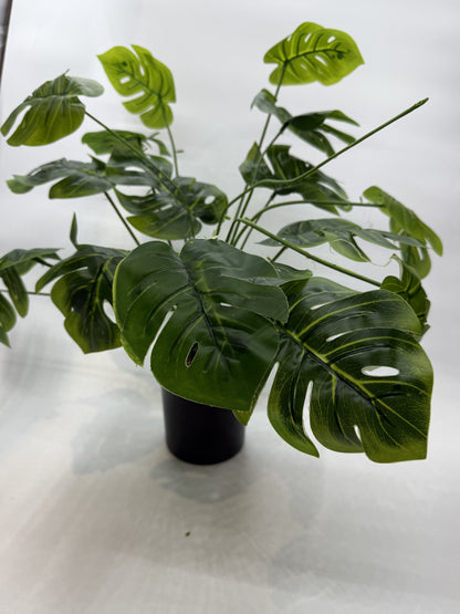 Lifelike Monstera artificial plant providing a natural look in a reptile enclosure.