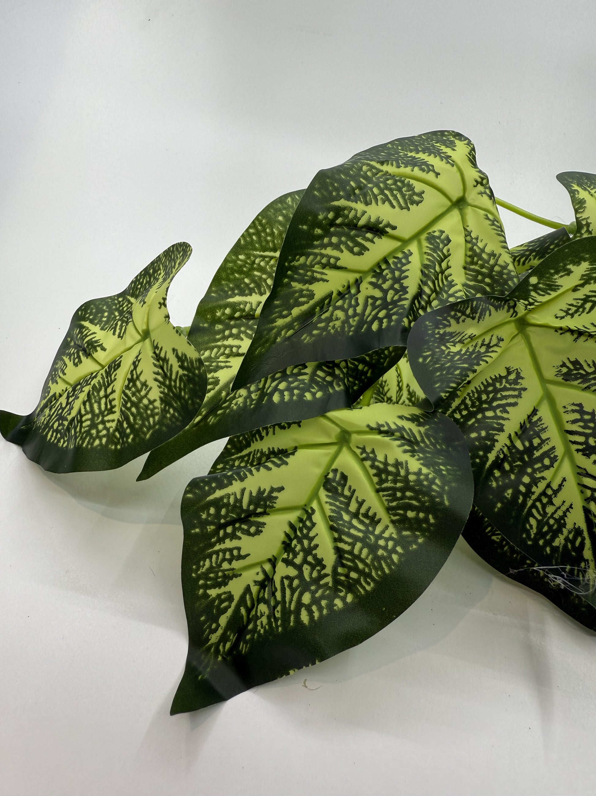 Lifelike Caladium artificial plant providing vibrant decor in a reptile enclosure.