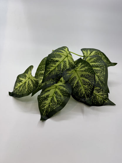 Lifelike Caladium artificial plant providing vibrant decor in a reptile enclosure.