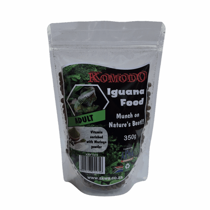 A stand-up resealable pouch of Komodo Iguana Food Adult, containing dark pellets, with a black and green label on a light gray background.