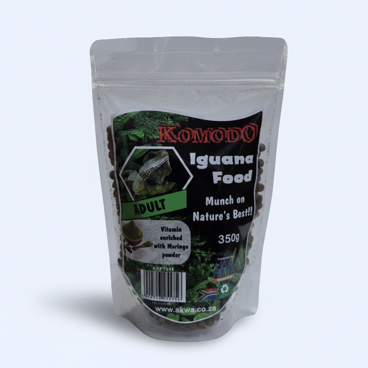 A 350g stand-up pouch of Komodo Iguana Food Adult, containing dark brown pellets, shown against a light gray background.