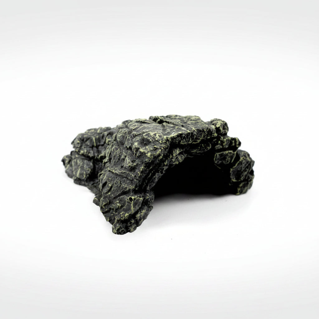 A dark gray and black textured rock cave hide with light green mossy accents, shown on a solid white background.