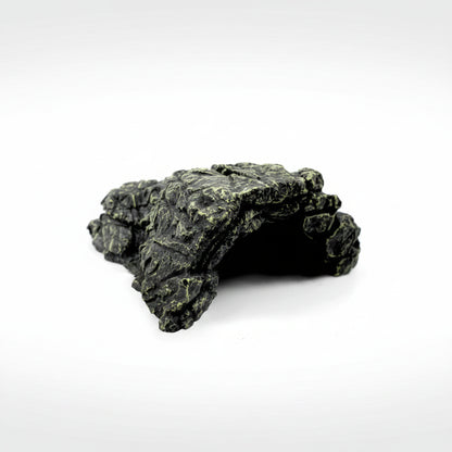 A dark gray and black textured rock cave hide with light green mossy accents, shown on a solid white background.