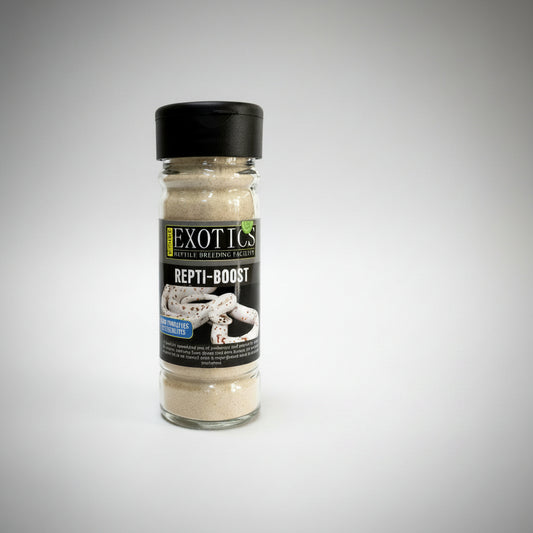A bottle of Exotics Repti-Boost reptile breeding supplement powder, featuring a black cap and a black label with white and yellow text, set against a plain white background.