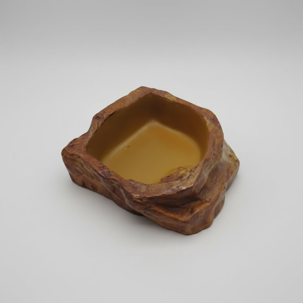 A reptile water dish with a naturalistic rocky brown
