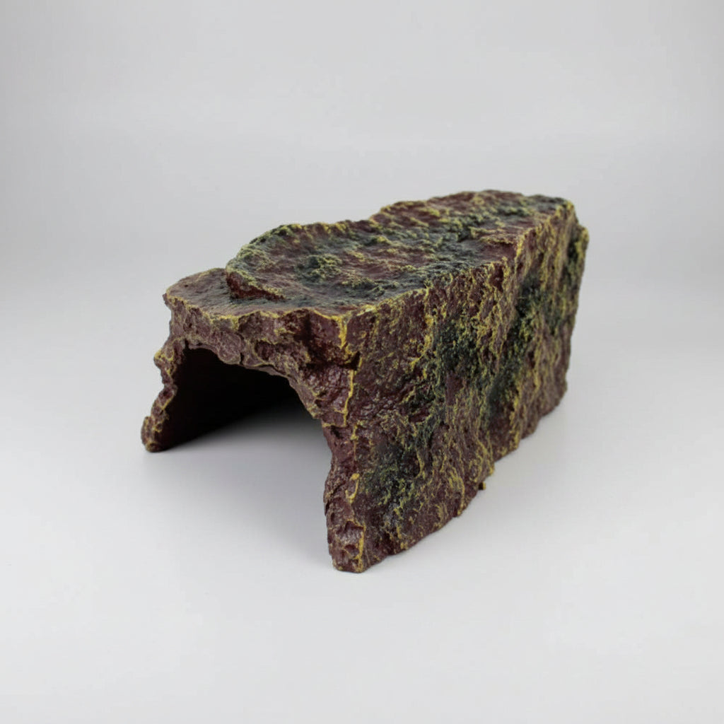 A small artificial rock hide or cave decoration with a rough, mossy textured surface, isolated on a white background.